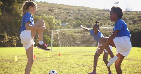 Diverse Female Teammates Practicing Soccer Drills in Park