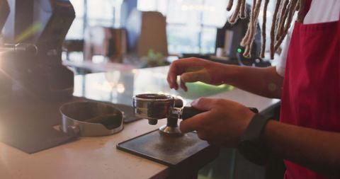 Barista Crafting Coffee with Dreadlocks and Portafilter Focus