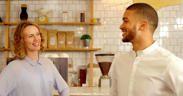 Smiling Barista Chatting with Colleague at Coffee Shop Counter - Download Free Stock Images Pikwizard.com