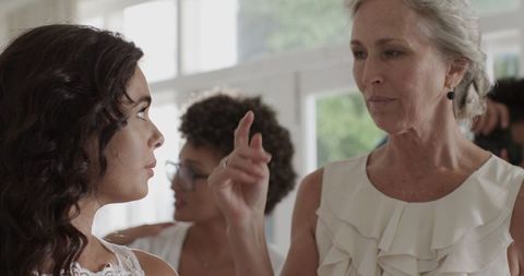 Women in Elegantly Dressed Attending Joyful Wedding Ceremony