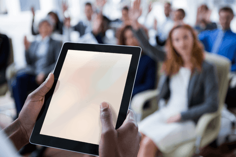 Businessperson Interacting with Transparent Tablet in Meeting