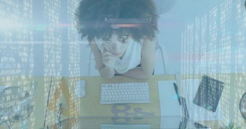 Thoughtful woman in modern office analyzing data on computer