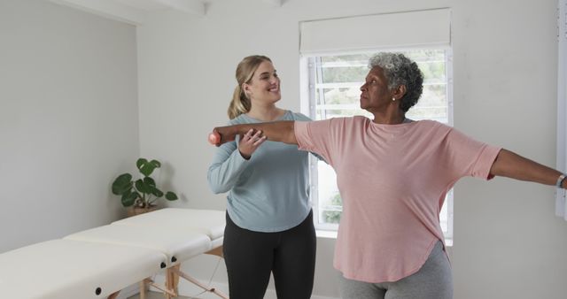 Caucasian female physiotherapist with senior woman exercising, copy space. Senior lifestyle, physiotherapist, healthcare services, care, medicine, profession, work concept, unaltered.