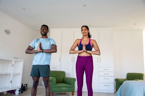 Diverse Fitness Partners Practicing Yoga at Home in Sportswear