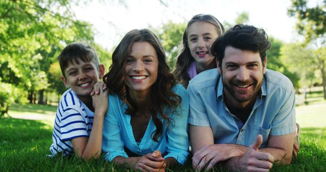 Happy Family Laying on Grass in Park on Sunny Day - Download Free Stock Images Pikwizard.com