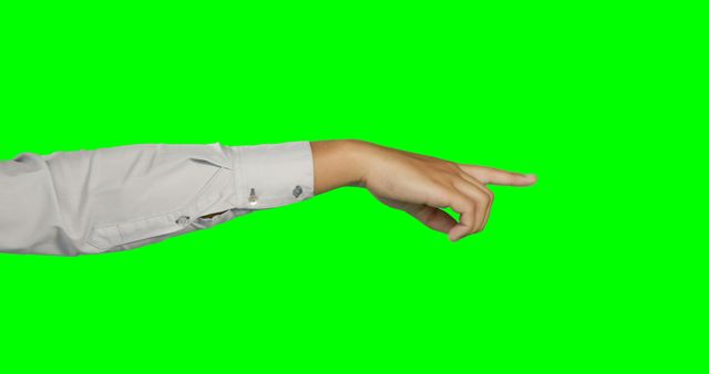 A Caucasian hand is extended with a pointing gesture against a green screen background, with copy space. Ideal for compositing graphics or text, the image provides a versatile backdrop for various design projects.