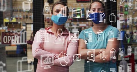 Masked small business owners standing confident behind storefront glass with tech icons