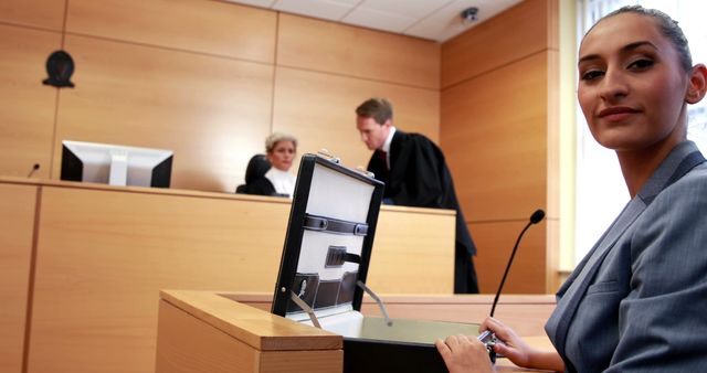 A young Caucasian woman, a lawyer or witness, is seated at a desk in a courtroom, with copy space - Download Free Stock Photos Pikwizard.com