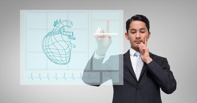Businessman interacting with human heart hologram on digital screen. Ideal for illustrating concepts related to modern technology, healthcare innovation, medical advancements, or executive decision-making in tech industries. Perfect for websites, presentations, and advertisements focusing on futuristic and tech-driven healthcare solutions.
