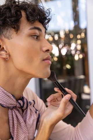 Elegant male grooming with makeup and fashion accessories