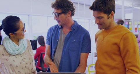 Creative Team Collaborating on Project in Modern Open Plan Office