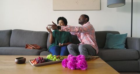 African American Couple Discussing TV in Cozy Living Room