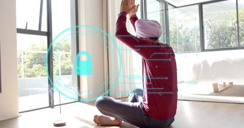 Indian man in turban meditating with ar lock overlay in sunlit minimalist bedroom
