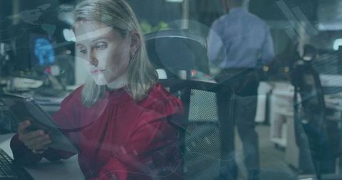 Caucasian Businesswoman Engaged with Tablet in Futuristic Office