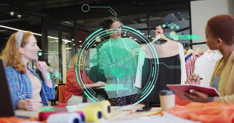 Creative design team reviewing fashion concepts at modern studio