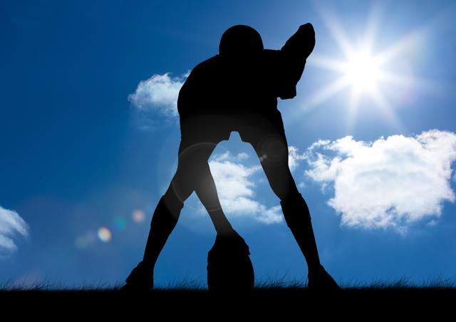 Digital composition of silhouette of player holding a rugby ball on grass against sky in background