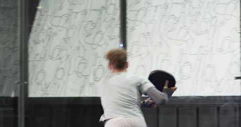 Male Athlete Playing Paddle Tennis on Modern Indoor Court