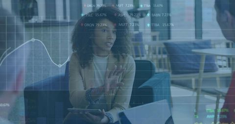 Businesswoman Explaining Financial Data with Charts and Tablet in Modern Office