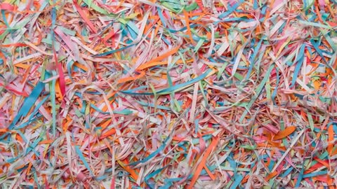 Shredded Paper Strips Settling on Flat Surface in Slow Motion Overhead Flatlay Texture