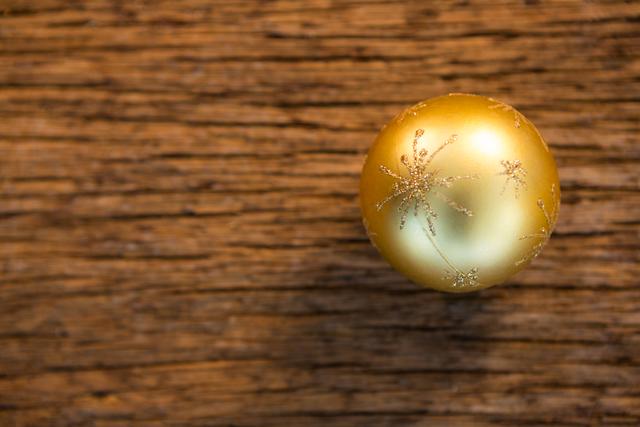 Christmas bauble ball on wooden plank during christmas time