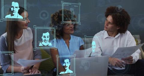 Team collaborating and discussing documents while using holographic facial-data overlays