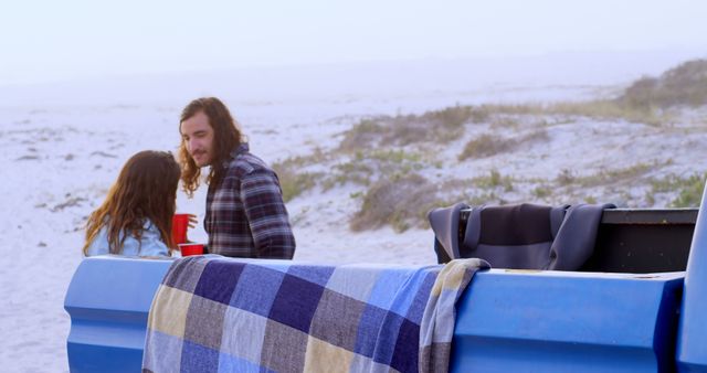 Young Couple Enjoying Beach Sunset Sitting On Truck Tailgate - Download Free Stock Images Pikwizard.com