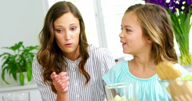 Mother and Daughter Having Candid Conversation in Kitchen - Download Free Stock Images Pikwizard.com