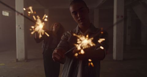 Young Adults Celebrating with Sparklers in Urban Setting - Download Free Stock Images Pikwizard.com
