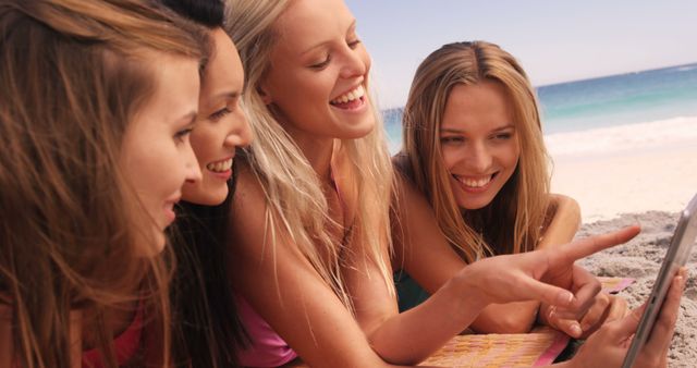 Group of Young Women Laughing While Using Digital Tablet at the Beach - Download Free Stock Images Pikwizard.com