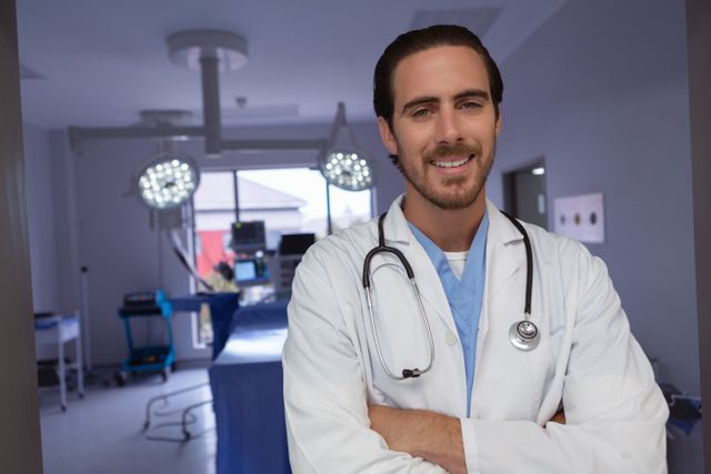Male doctor standing confidently in a modern operating room, wearing a white coat and stethoscope. Ideal for use in healthcare, medical, and hospital-related content, showcasing professionalism and medical expertise.
