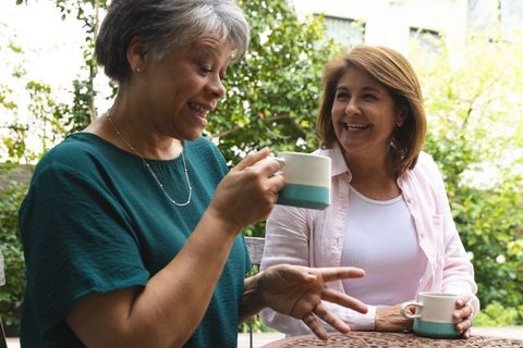 Diverse Women Enjoying Coffee in Garden Setting