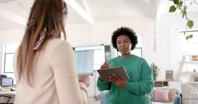 Two Professionals Discussing Information on Digital Tablet in Modern Office - Download Free Stock Images Pikwizard.com