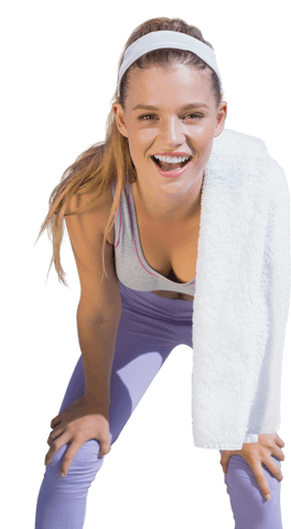 image features a smiling young woman resting after workout, leaning slightly forward with hands on knees. she is dressed in workout clothes with a towel draped over her shoulder. ideal for use in fitness articles, gym promotions, or active lifestyle branding for adding vibrant energy and health-focused imagery.