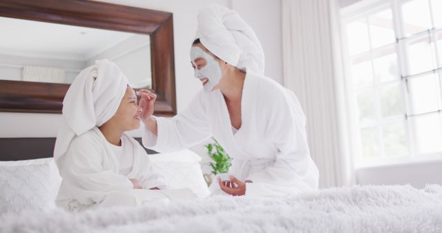 Mother and Daughter Enjoying Spa Day with Face Masks and Towels on Heads - Download Free Stock Images Pikwizard.com