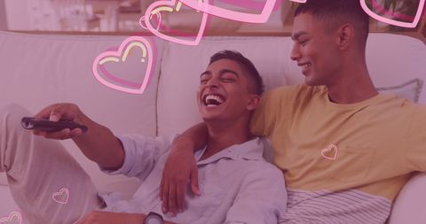 Happy Biracial Gay Couple Relaxing Together on Couch