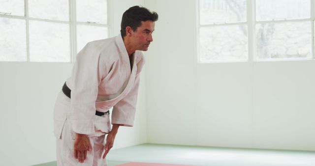 Karate Master Bowing in Traditional White Dojo - Download Free Stock Images Pikwizard.com