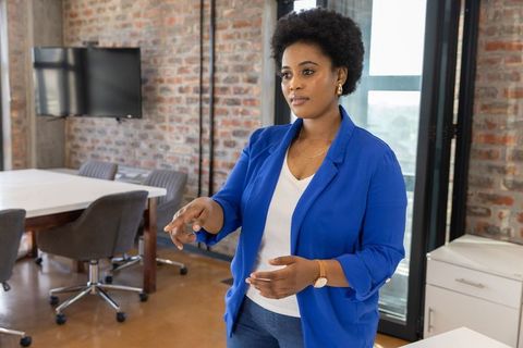 Confident african american woman presenting in modern office