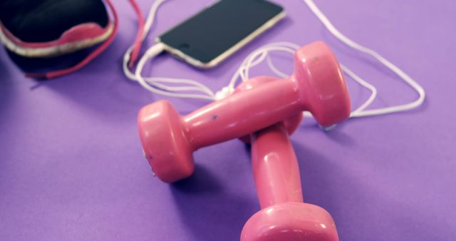 Pink Dumbbells with Smartphone and Headphones on Purple Background - Download Free Stock Photos Pikwizard.com