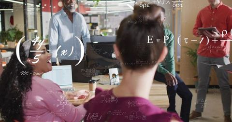 Collaborative startup team brainstorming with scientific formulas overlay in modern office