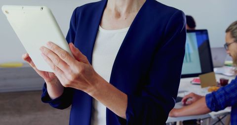 Business Professional Working on Tablet in Modern Office