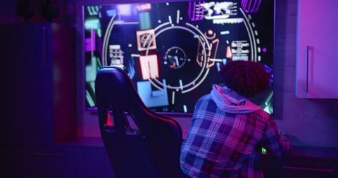 Gamer in Plaid Immersed in Multiplayer Video Game Experience