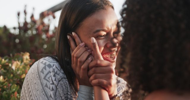 Happy romantic biracial lesbian couple talking and embracing in garden at sundown, slow motion - Download Free Stock Photos Pikwizard.com