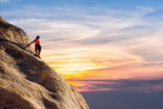 Person climbing a steep rock face with a vibrant sunrise in the background. This image captures the essence of outdoor adventure and the spirit of determination and challenge. Ideal for promoting adventure sports, travel, fitness activities, and motivational content.