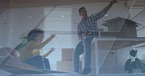 Couple arranging new home, woman pointing while man planning living room with boxes