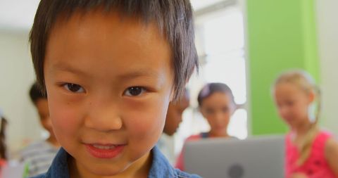 Cheerful Asian Schoolboy Standing in Colorful Classroom - Download Free Stock Images Pikwizard.com