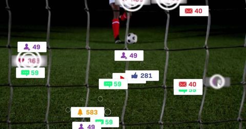 Goal framed through net on night soccer pitch with social media notification overlays