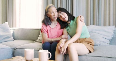 Elderly Woman Comforting Teenage Granddaughter at Home