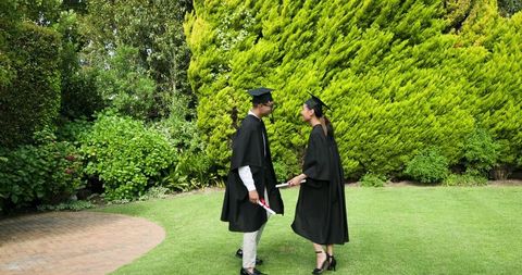 Graduates celebrating in scenic garden