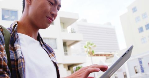 Young Asian Professional Using Tablet in Urban Environment - Download Free Stock Images Pikwizard.com
