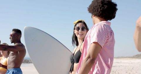 Friends Gathering on Beach for Sunny Surf Day